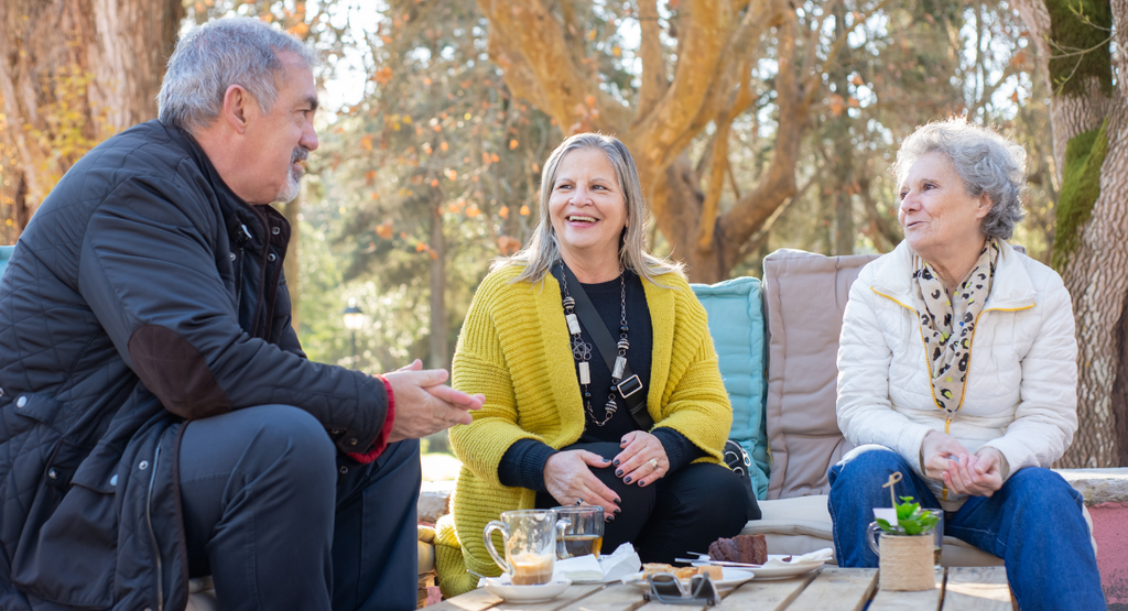 Family and friends having a relaxed outdoor conversation
